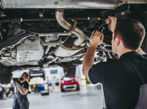 Mechanics working on a vehicle at The TyreWarehouse